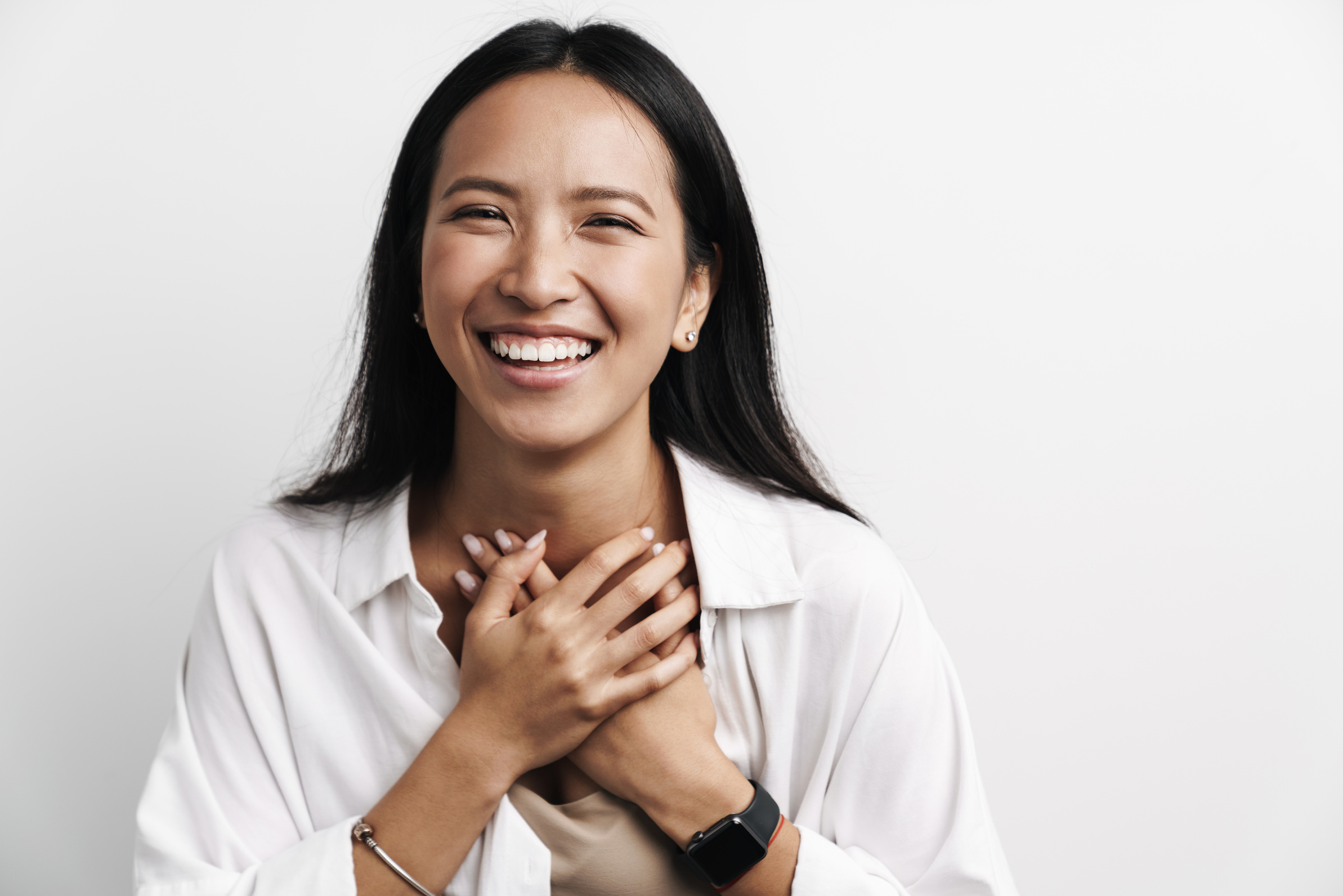 Beautiful Happy Asian Woman Laughing While Posing with Hands Her Chest