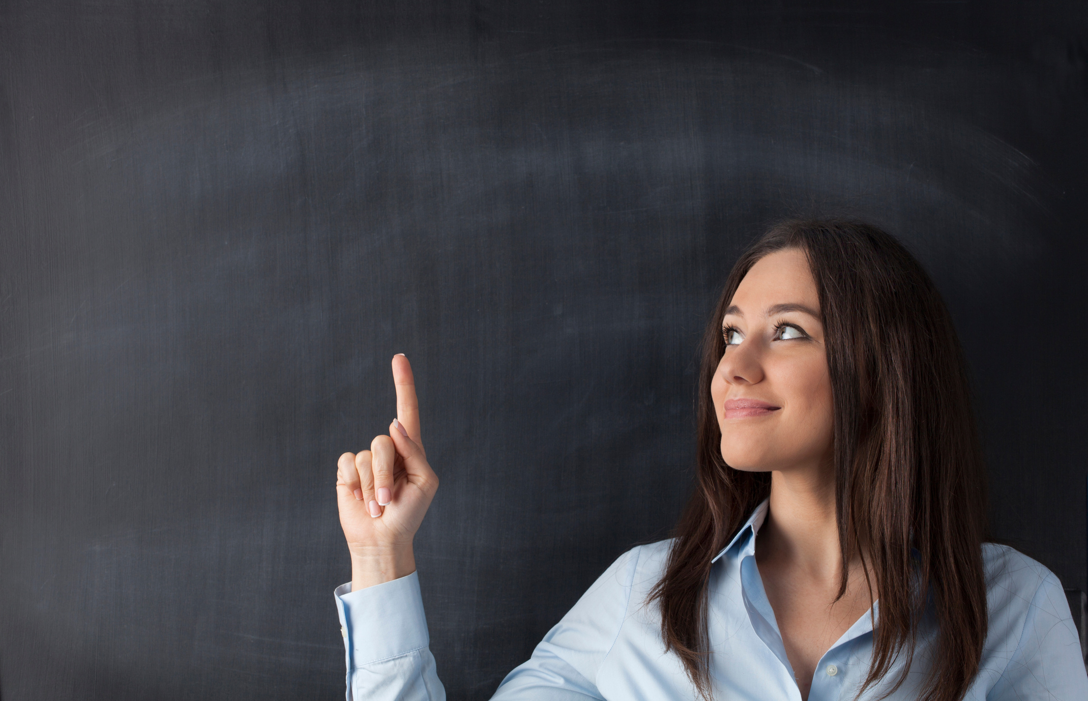 Happy young woman pointing